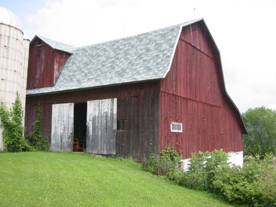 Image of a basement barn from Tioga County that has a gambrel roof and shed extension