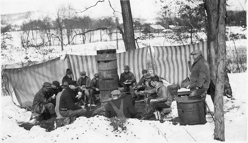 WPA field crew at the Hanna site breaks for lunch, shielded from the fierce winter winds by three canvases.
