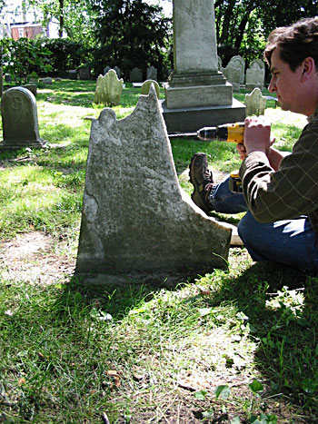 Skilled technician pinning a headstone