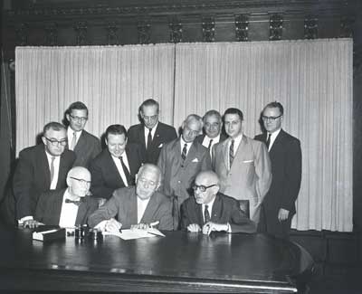 Image of Governor Lawrence and others at the 1961 signing of the Urban Renewal Bill