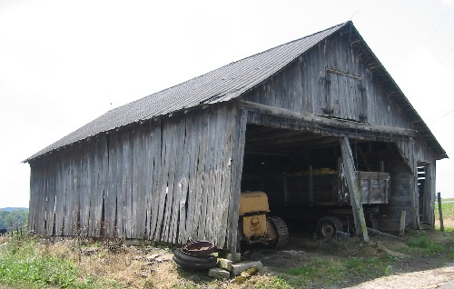 A combination structure made up of a machine shed and corn cribs.