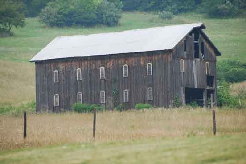 Image of a wood frame sheep shed with louvered windows in Washington County