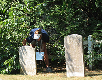 Surveyor reviewing headstone