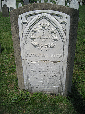 Broken headstone encased in concrete